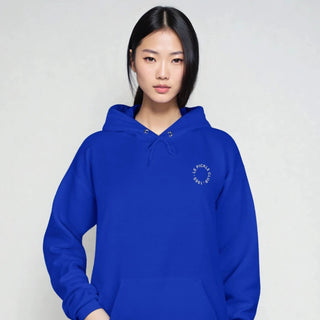Person wearing a blue hoodie with a logo on a plain background