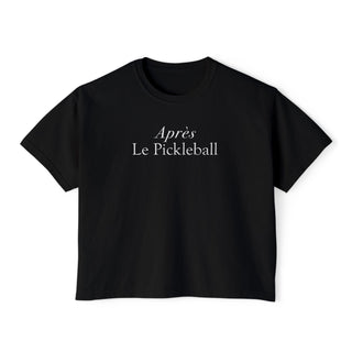 A black crop tee with 'Aprés Le Pickleball' printed in white on the front.
