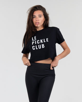 Woman wearing a black 'LE PICKLE CLUB' t-shirt against a white background