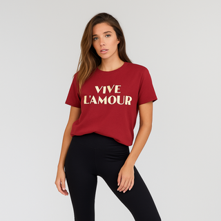 Woman wearing a red t-shirt with 'Vive L'Amour' text, black leggings, and white sneakers on a light gray background