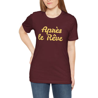 Woman wearing a maroon t-shirt with yellow text on a white background