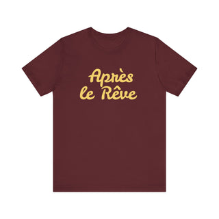 Maroon t-shirt with yellow text 'Apres le Reve' on a white background
