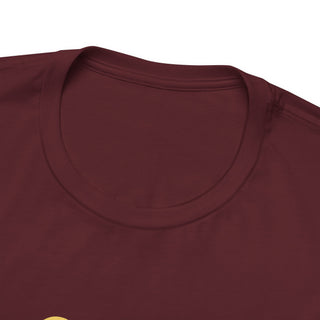 Close-up of a maroon shirt with a visible brand logo on a white background