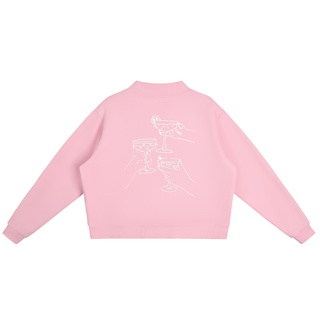 Pink sweatshirt with white graphics on the back against a white background
