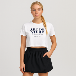 Woman wearing a white t-shirt with 'ART DE VIVRE' text and a black skirt on a plain background