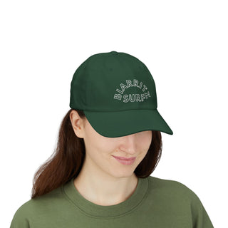 Person wearing a green cap with 'BIARRITZ SURF' text on a white background