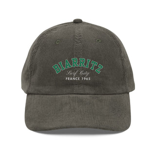 Gray cap with green text on a white background