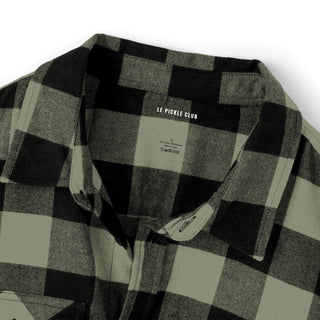 Black and olive checkered shirt with 'Le Pickle Club' label on a white background