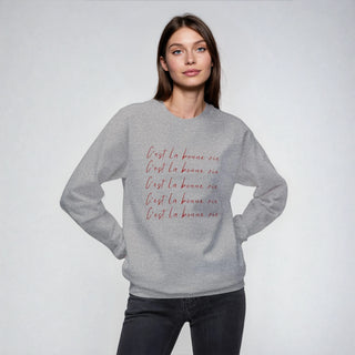 girl wearing a gray sweatshirt with text on a white background