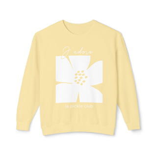 A yellow crewneck sweatshirt with a white text and flower graphic on the front.
