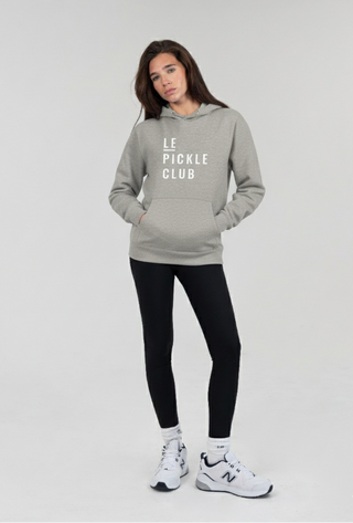 Person wearing a gray hoodie with 'Le Pickle Club' text on a white background