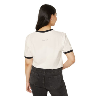 Person wearing a white t-shirt with black trim and black pants on a white background