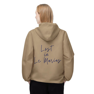 Person wearing a beige hoodie with 'Lost in Le Marais' text on the back against a white background
