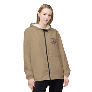 Woman wearing a beige hoodie with a logo on a white background
