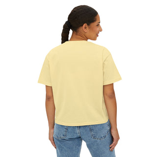 Woman wearing a light yellow t-shirt and blue jeans on a white background
