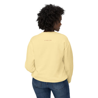 Person wearing a light yellow sweatshirt with text on the back, standing against a white background