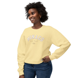Woman wearing a yellow sweatshirt with 'MONACO' text on a white background