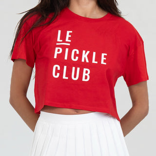 Person wearing a red 'LE PICKLE CLUB' t-shirt on a white background