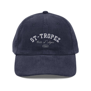 Navy blue cap with 'St-Tropez' text on a white background