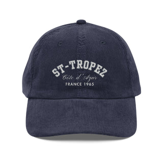 Navy blue cap with 'St-Tropez Cète d'Azur France 1965' text on a white background