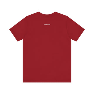 Red t-shirt with a small white logo on the back against a white background